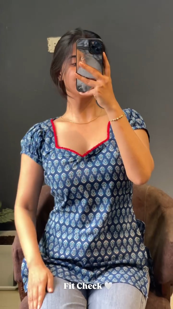 blue and white patterned kurti with a distinctive red border