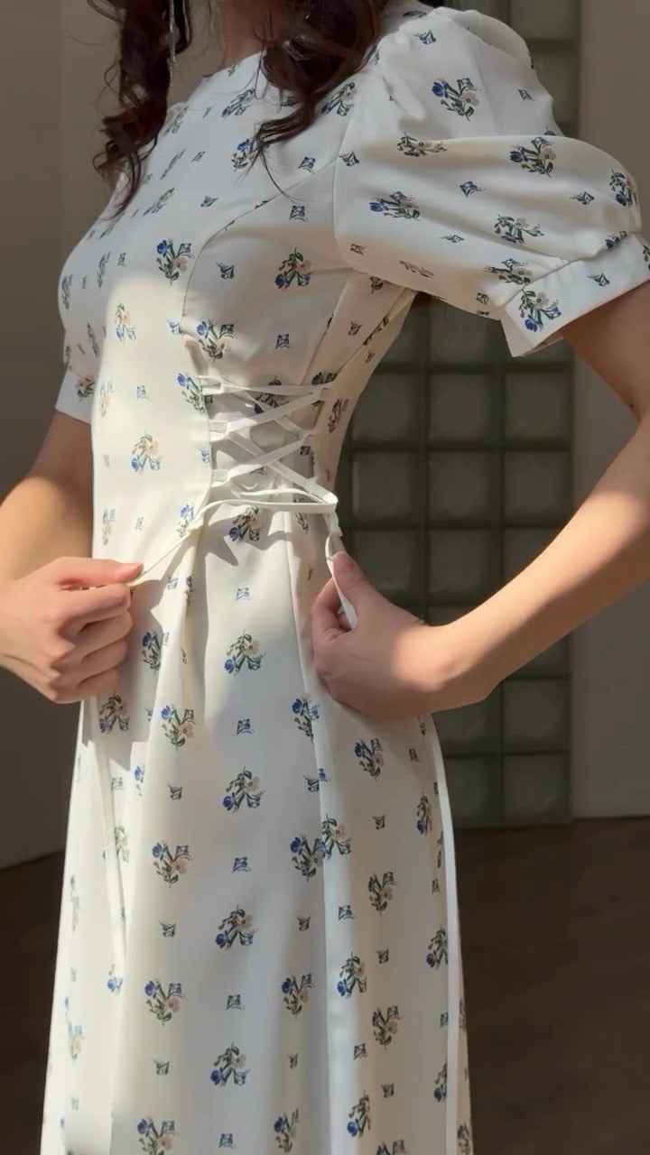 white midi dress with a blue floral print ( fabric is likely breathable, Poly rayon)