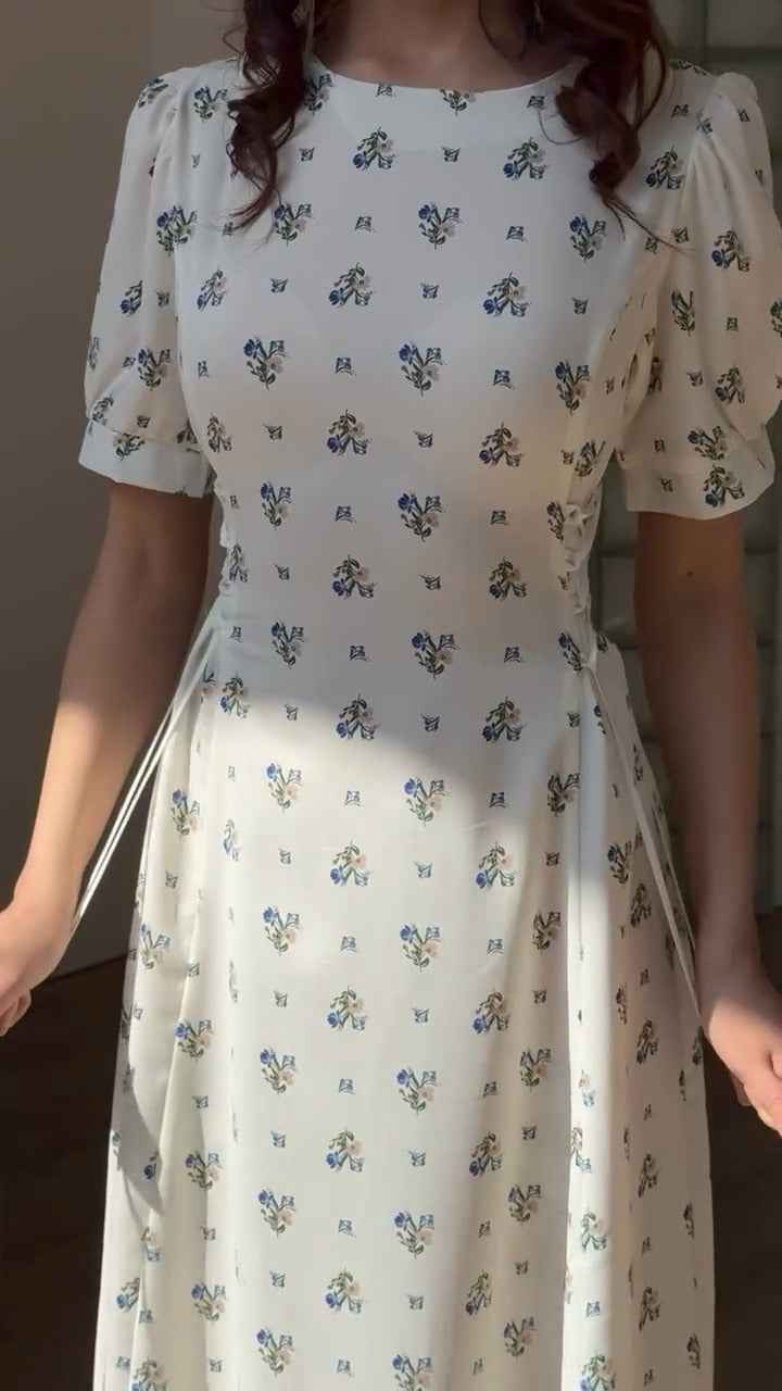 white midi dress with a blue floral print ( fabric is likely breathable, Poly rayon)