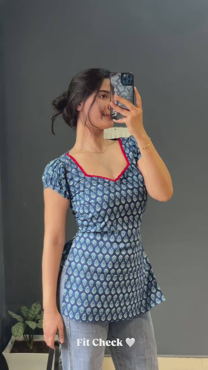 blue and white patterned kurti with a distinctive red border